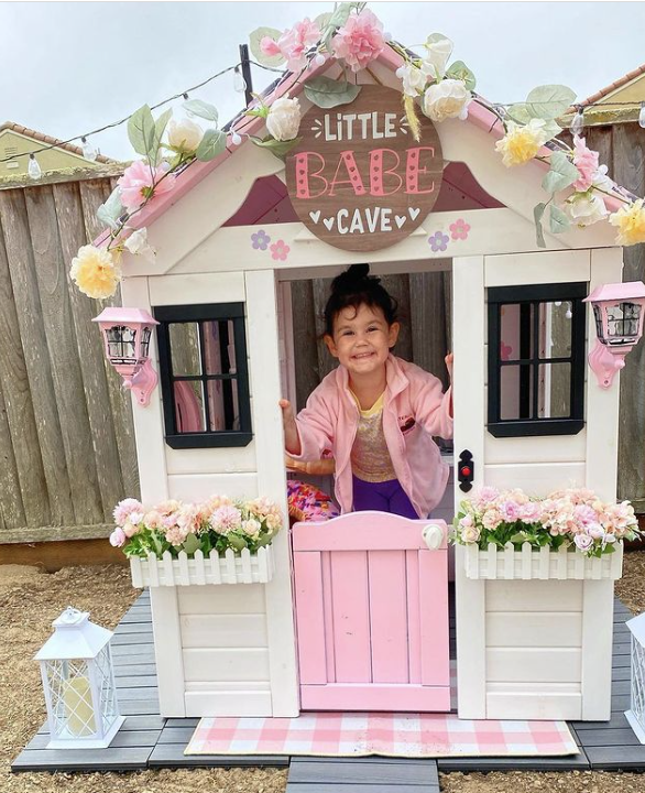 Girl playing in playhouse